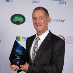 Craig posing for a photo with trophy